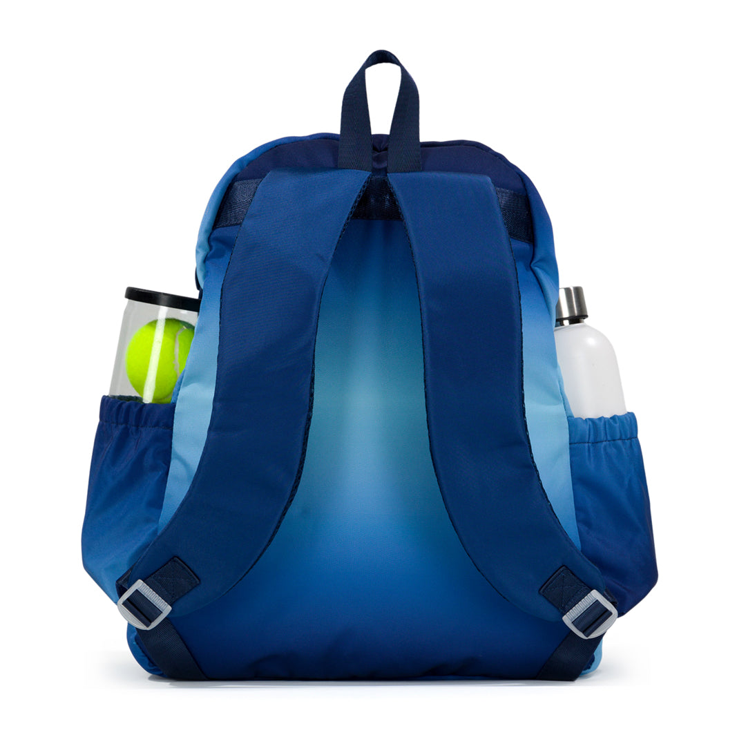 Back view of navy and blue ombre game on tennis backpack. Backpack has water bottle and tennis balls in side pockets.