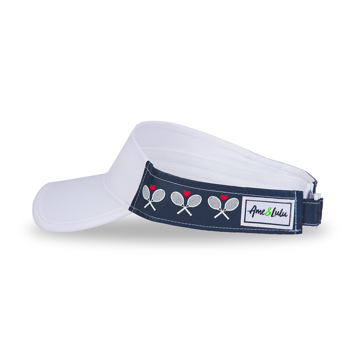 Side view of crossed racquets head in the game visor. Front of visor is white and sides are navy with white crossed racquets and red hearts printed.
