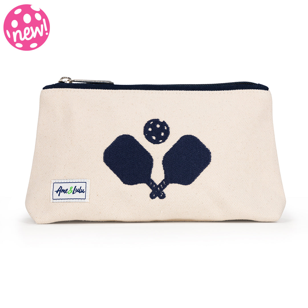 Front view of small natural canvas makeup pouch. Navy crossed paddles are embroidered on the front and navy trim on the zipper.