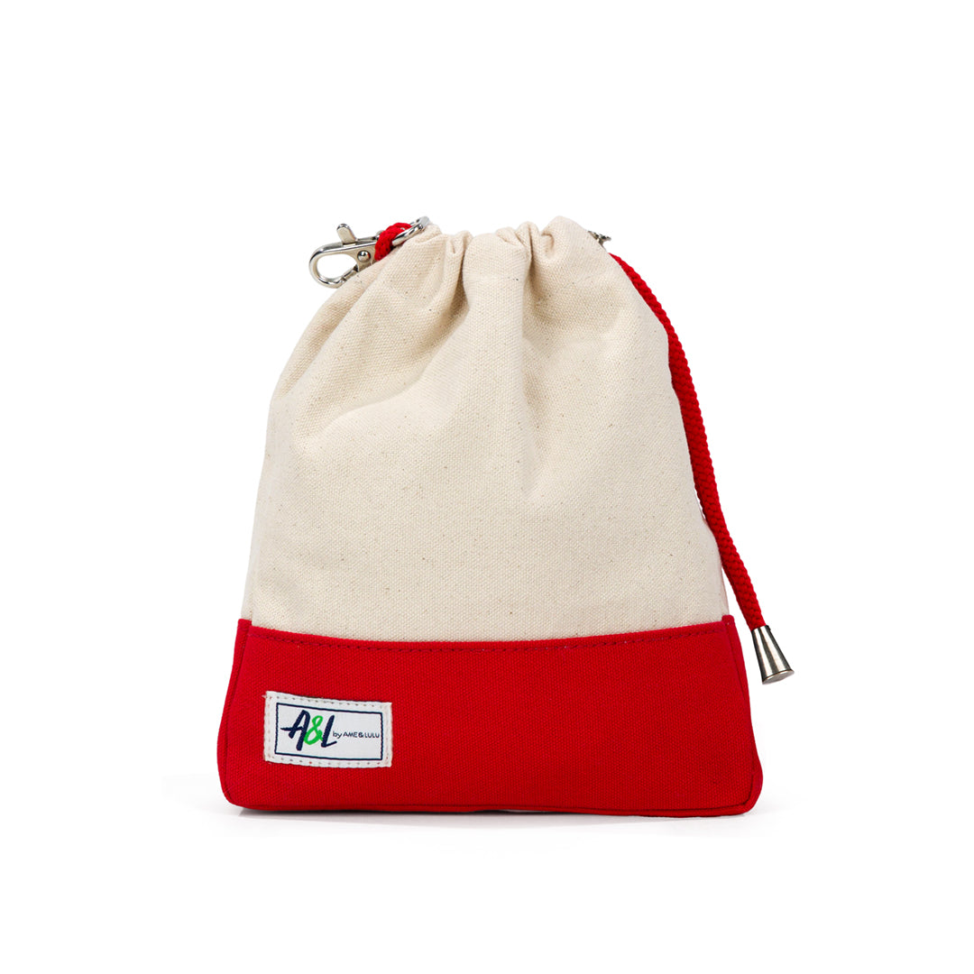 tan canvas small drawstring pouch with red trim.