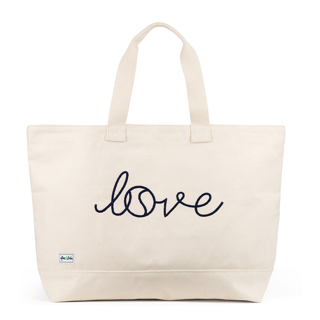 Canvas large tote with the front embroidered with the word love in a navy cursive font