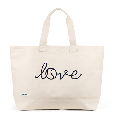 Canvas large tote with the front embroidered with the word love in a navy cursive font