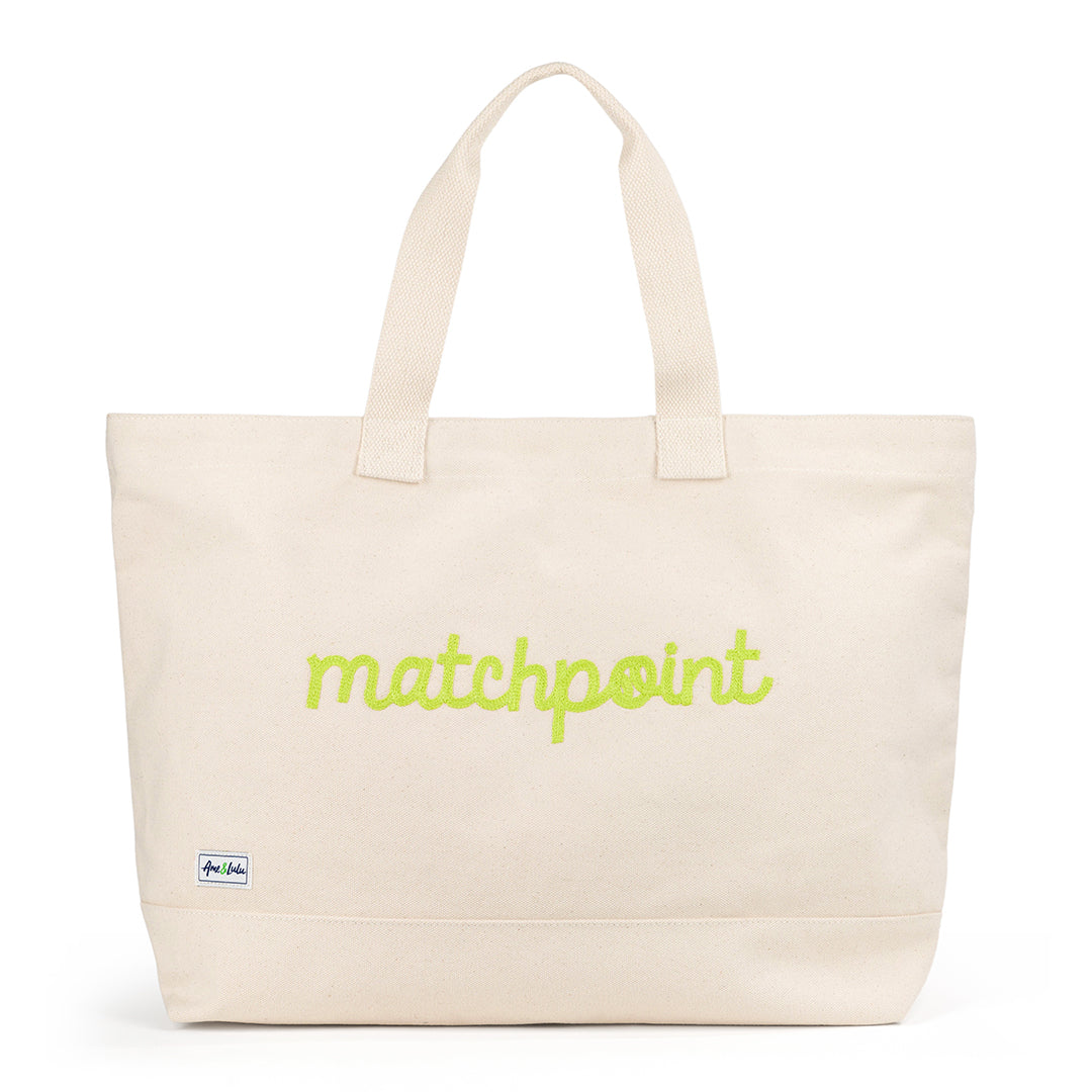 Canvas large tote with the front embroidered with the word matchpoint in a lime cursive font