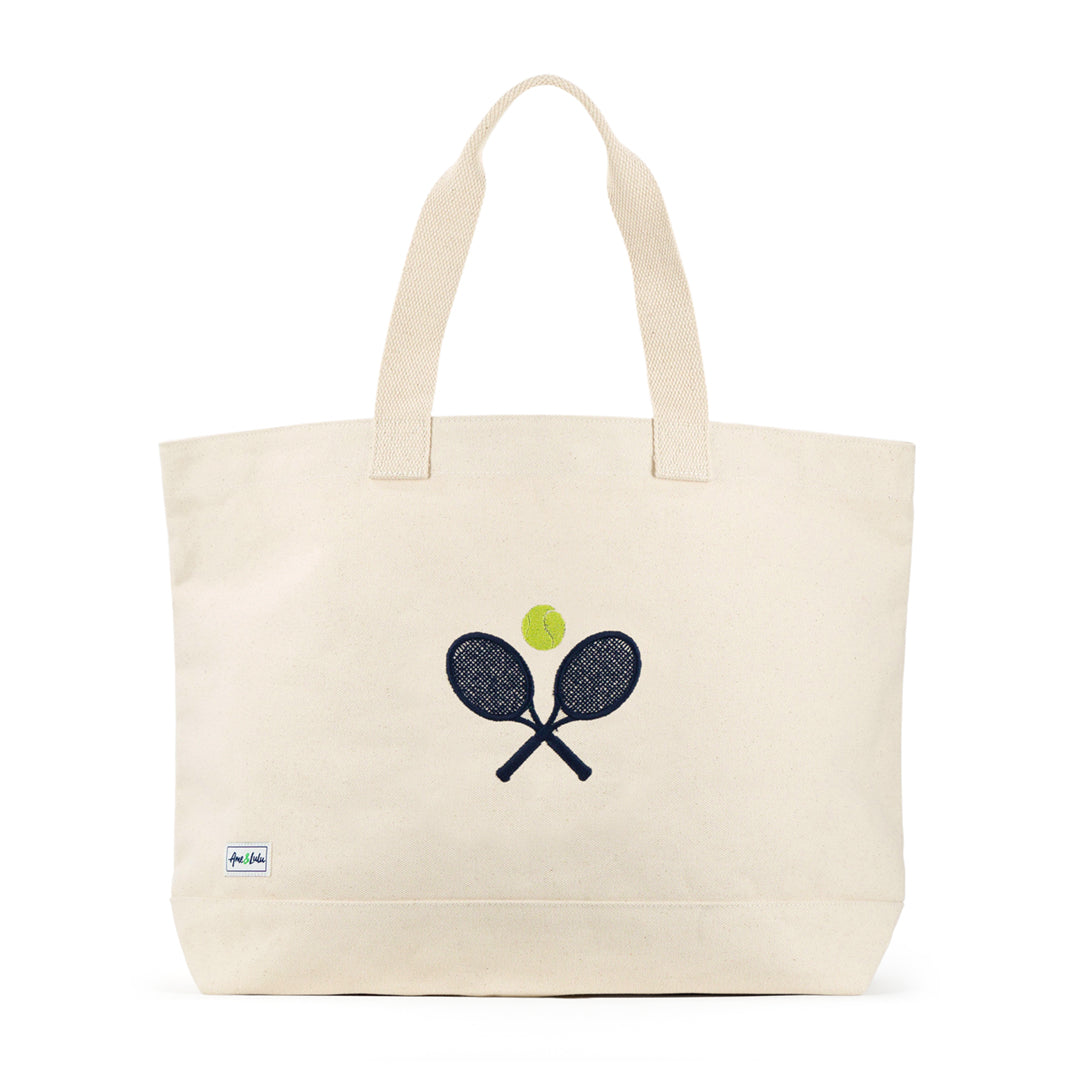 Front view of large canvas tote with crossed racquets and tennis ball embroidered on front.