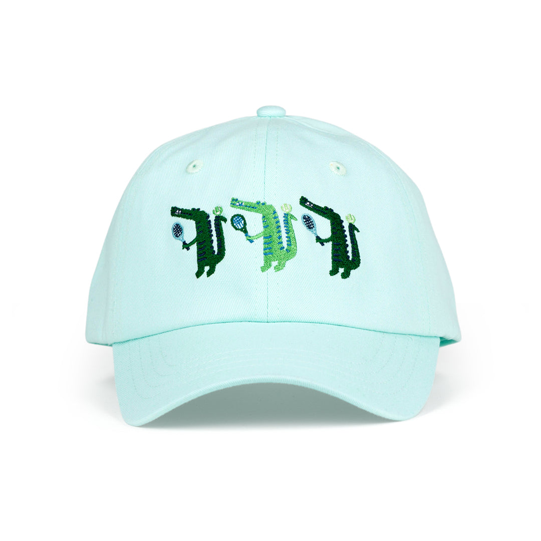Front view of light blue kids baseball hat with alligator playing tennis embroidered on the front