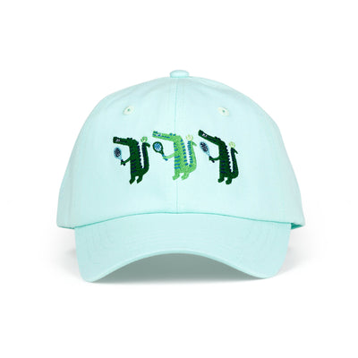 Front view of light blue kids baseball hat with alligator playing tennis embroidered on the front