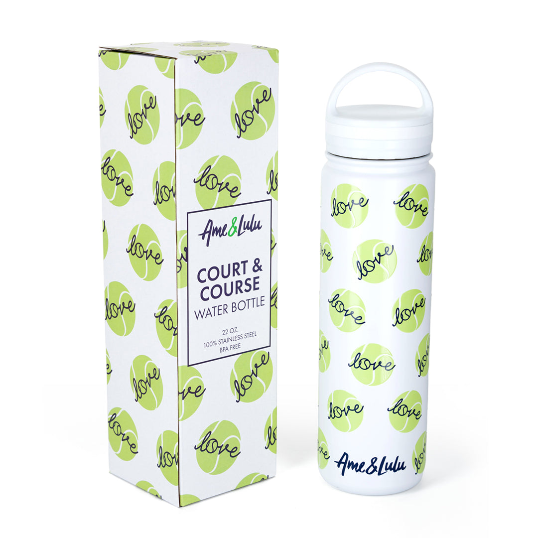 White water bottle with repeating green tennis balls and navy love text pattern on the bottle. Next to bottle is box packaging matching the bottles pattern