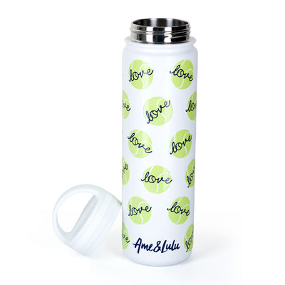 White water bottle with repeating green tennis balls and navy love text pattern on the bottle. Top is off of bottle and next to it