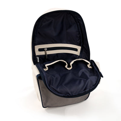 Inside view of Hamptons pickleball sling bag. Bag has front mesh pocket and slip pocket on front to hold pickleball paddles. Bag has navy trim and navy and white striped straps. Bag has adjustable straps to be worn as a backpack or a crossbody.