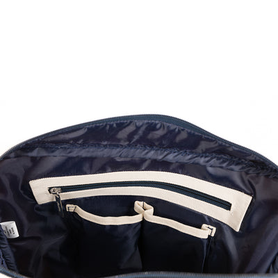 inside view of Natural canvas tennis tote with navy trim and navy and pink striped handles. Front pocket holds multiple tennis racquets.