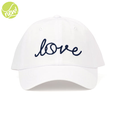 White baseball hat on white background with word "love" embroidered on the front in navy cursive