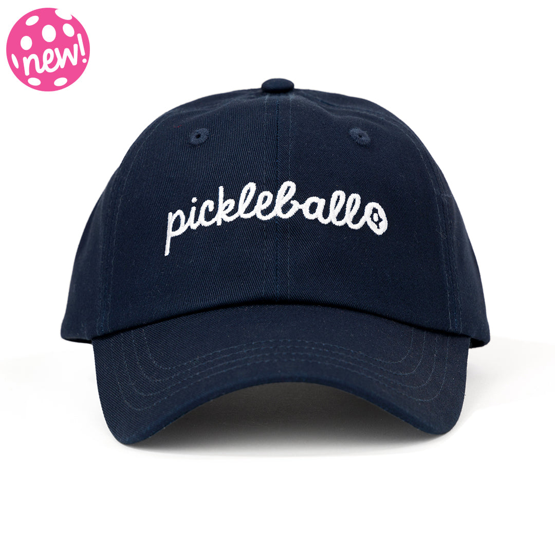 Navy baseball hat on white background with the word pickleball embroidered on the front in cursive