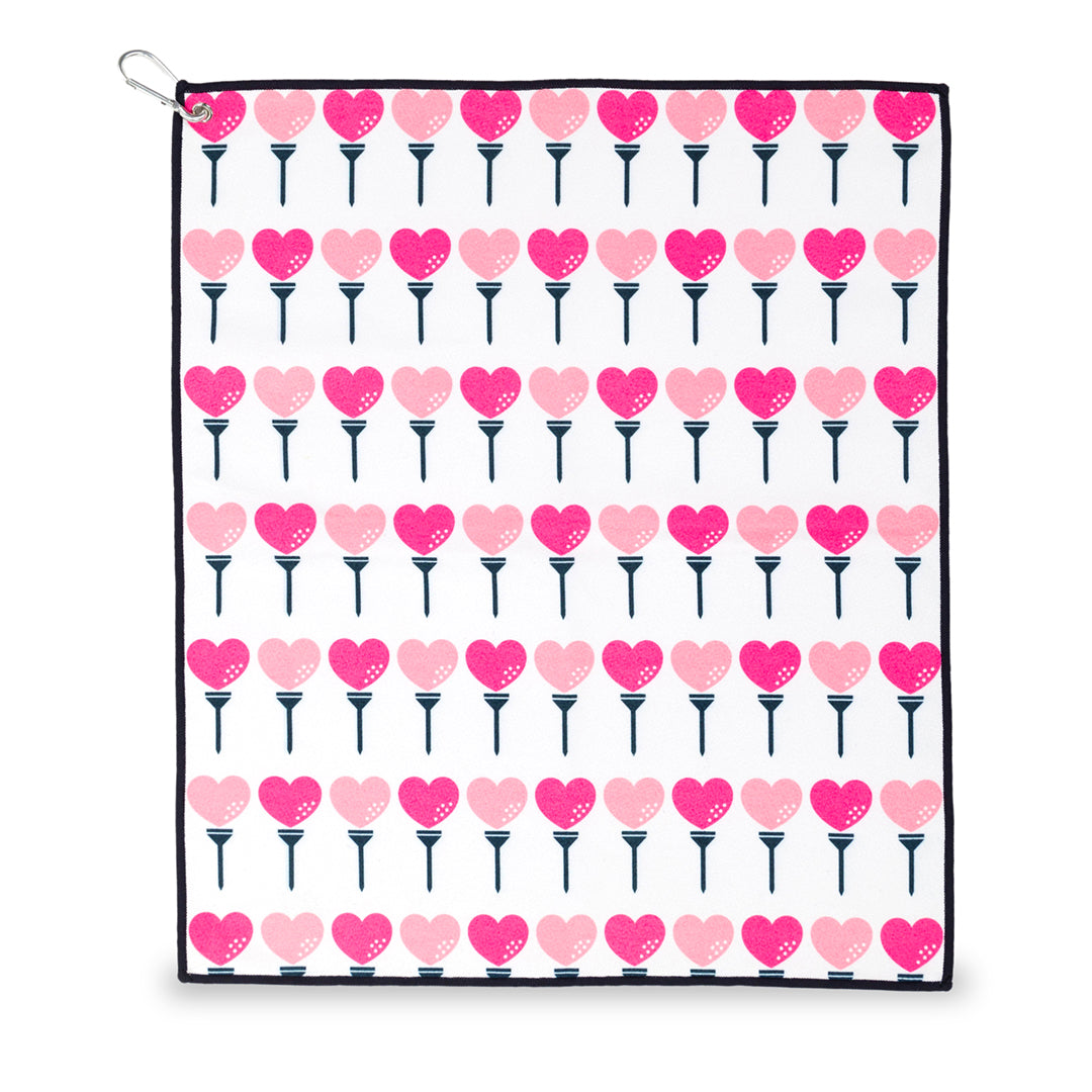 small white towel with hot pink and pink heart shaped golf balls and tee