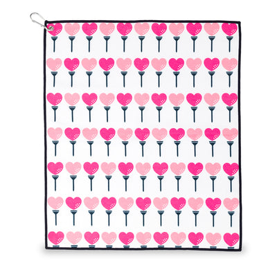 small white towel with hot pink and pink heart shaped golf balls and tee