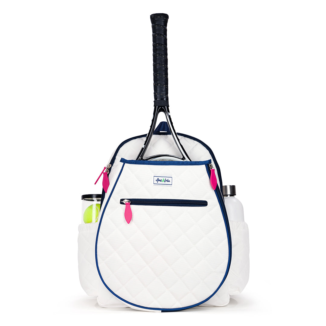 Front view of quilted white kids tennis backpack with navy trim and hot pink zippers.