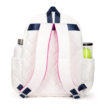 Back view of quilted white kids tennis backpack with navy trim and hot pink zippers.