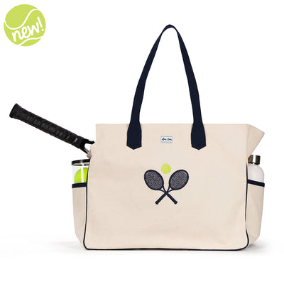 Natural canvas tote with navy straps and front panel embroidered with navy crossed racquets and lime tennis ball.