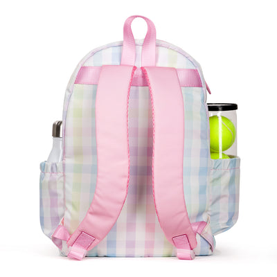 back view of rainbow gingham patterned kids tennis backpack with pink trim and zippers. Front pocket holds tennis racquets