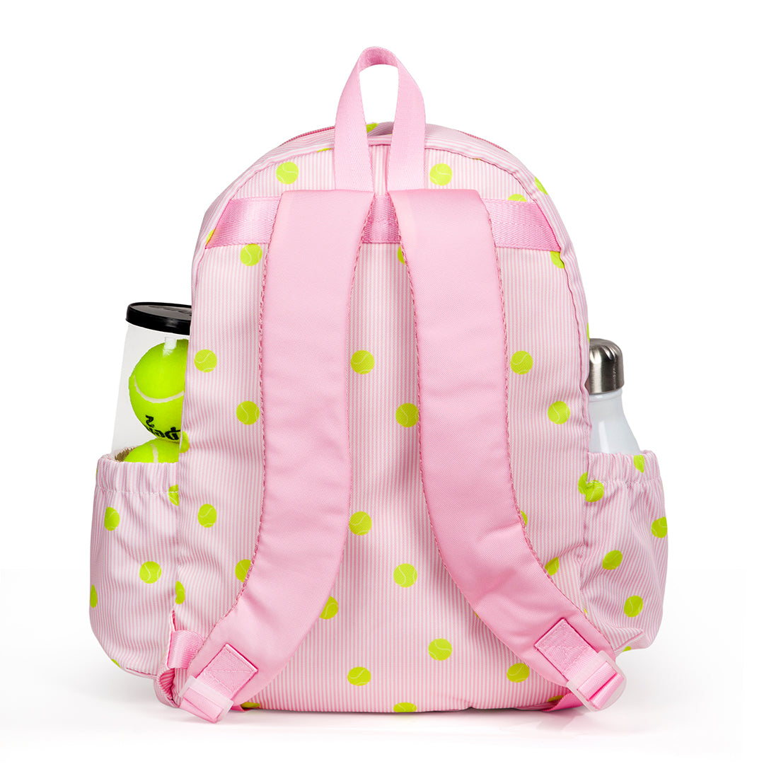 Kids tennis backpack with front pocket to hold tennis racquet. Bag is printed with a pink and white striped pattern and repeating tennis balls on the stripes.