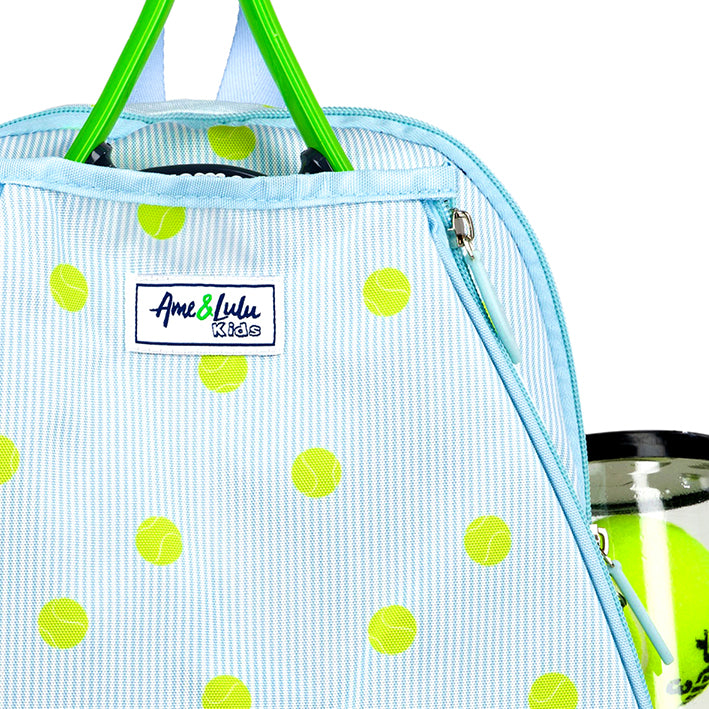 Kids tennis backpack with front pocket to hold tennis racquet. Bag is printed with a blue and white striped pattern and repeating tennis balls on the stripes.