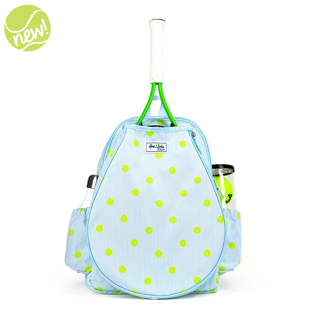 Kids tennis backpack with front pocket to hold tennis racquet. Bag is printed with a blue and white striped pattern and repeating tennis balls on the stripes.