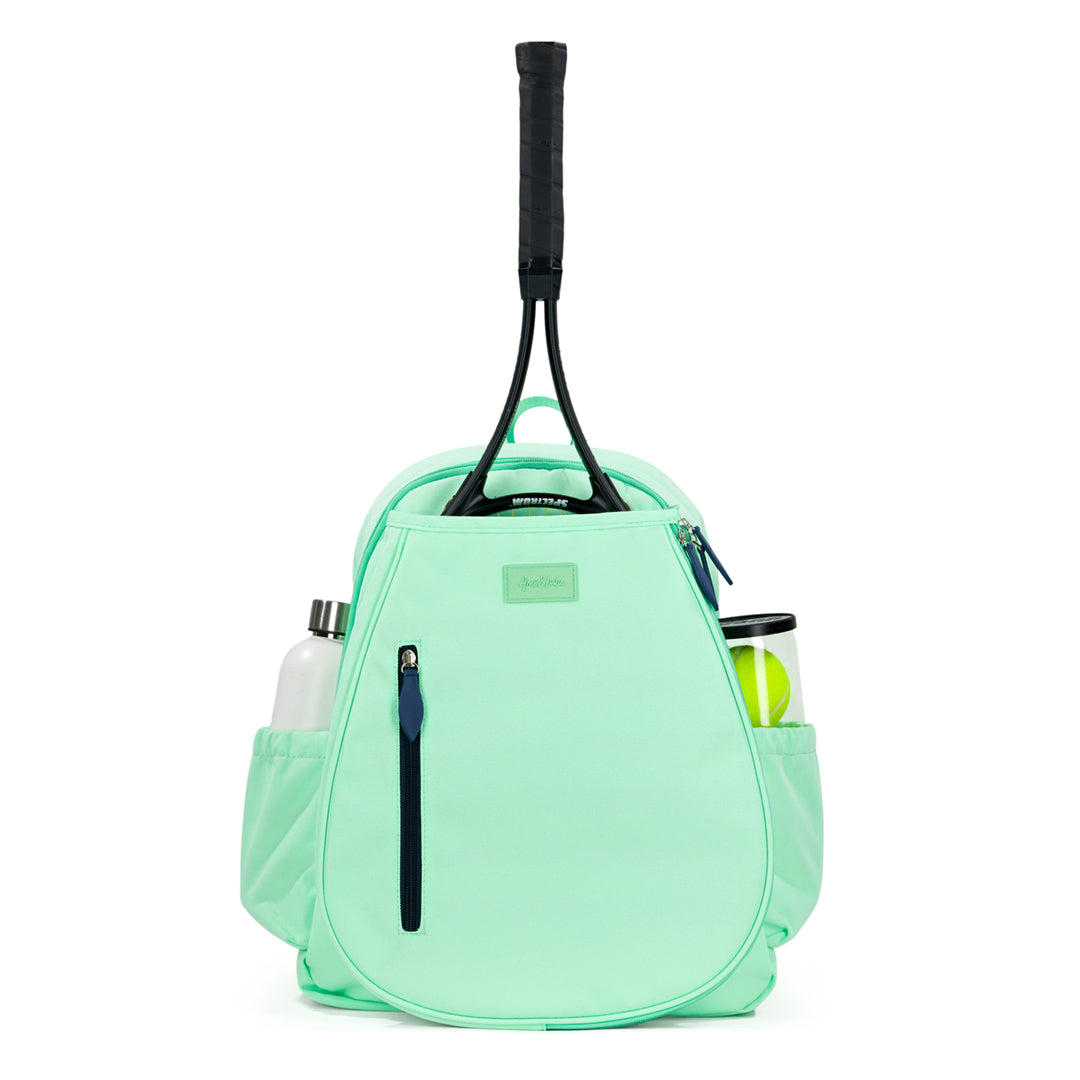 Front view of mint green game time tennis backpack with navy zipper on the front of the backpack. There is a tennis racquet in the front pocket.