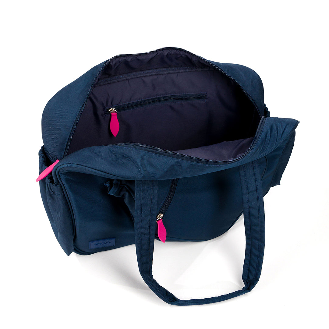 Inside view of navy pickleball tote with hot pink zipper pulls. Tote has pickleball paddle shaped front pocket and side pockets for water bottles.