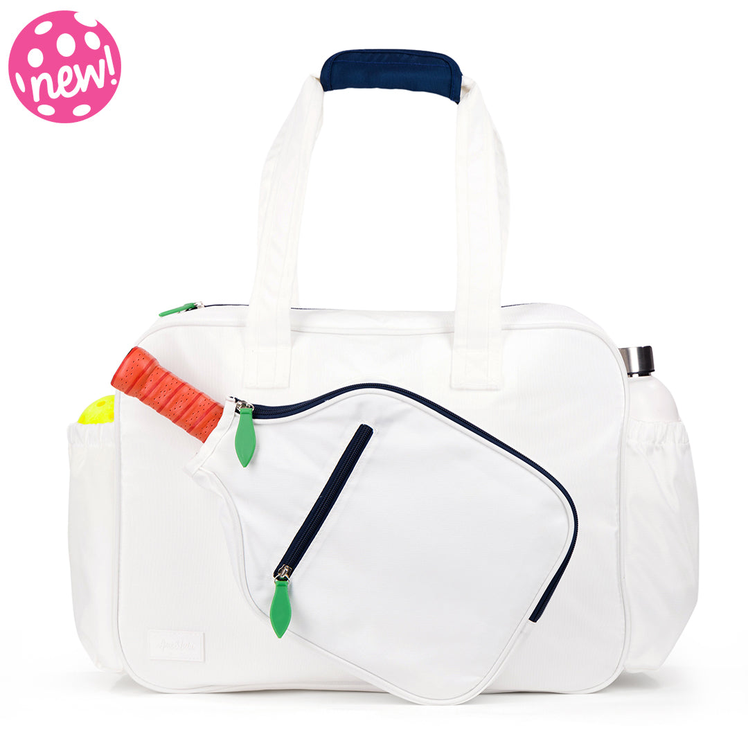 Front view of white pickleball tote with navy trim and green zipper pulls. Tote had front paddle pocket.