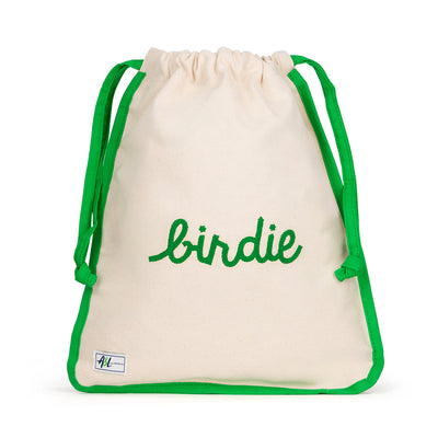 Front view of natural canvas shoe bag with green trim and the word "birdie" embroidered on the front in green.