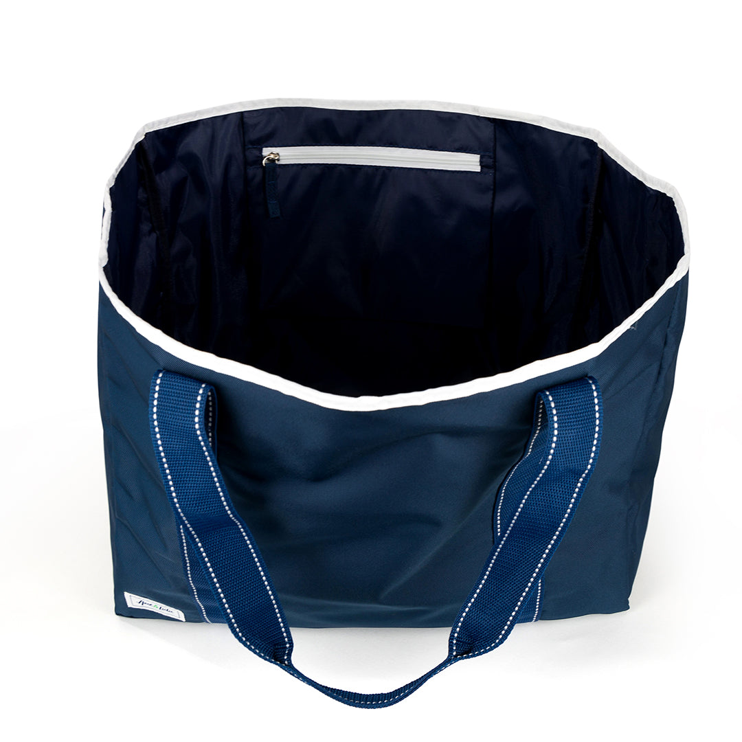 Inside view of navy beach tote with navy straps and white details.