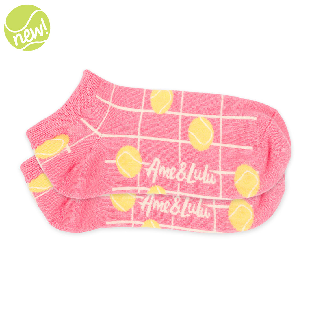 Pair of womens short socks in coral color with cream grid lines and yellow tennis balls stitched on them