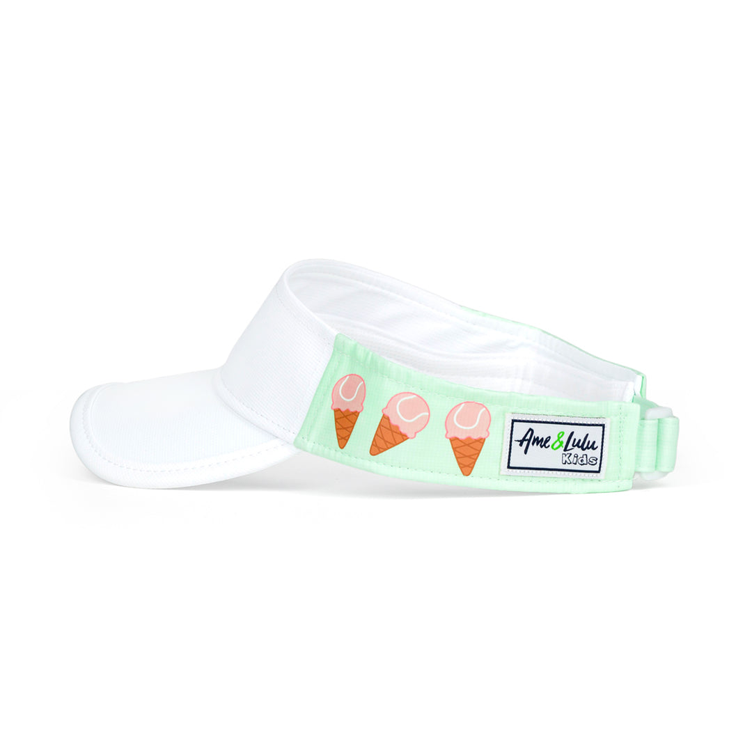 Side view of light green kids visor with pink tennis ball ice creams on the sides.
