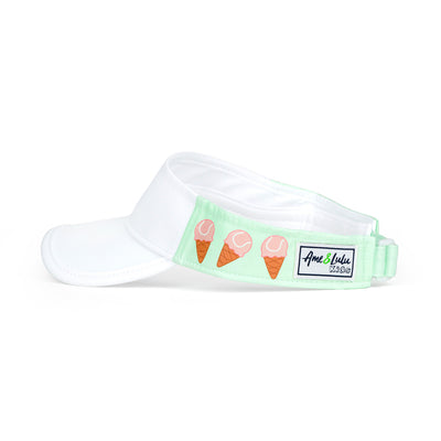 Side view of light green kids visor with pink tennis ball ice creams on the sides.