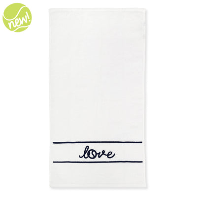 White terry towel laying flat on white background with navy stripes and the word love embroidered on it