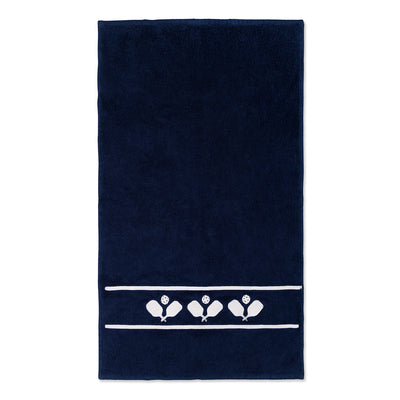 Navy cotton terry towel with three sets of white crossed paddles embroidered on the bottom of the towel