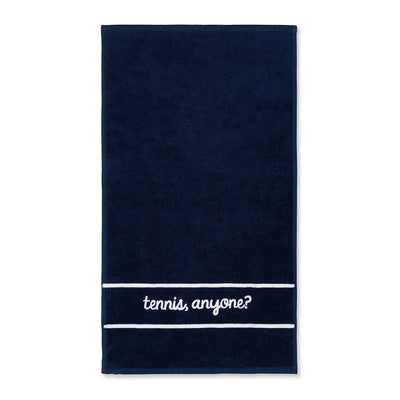 Navy cotton terry towel with the words "tennis anyone" embroidered in a cursive font in white on the bottom of the towel.