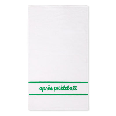 White cotton terry towel with "apres pickleball" embroidered in a green cursive font on the bottom of the towel