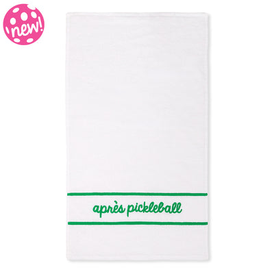White cotton terry towel with "apres pickleball" embroidered in a green cursive font on the bottom of the towel