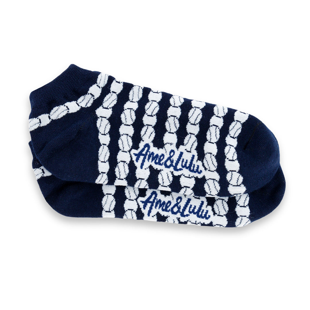 a pair of navy socks with white repeating tennis balls pattern