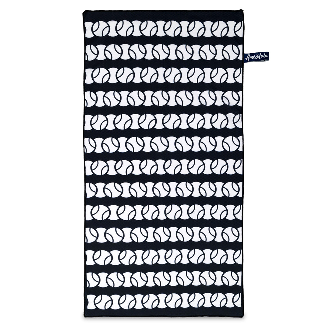 Navy rectangular towel with repeating white tennis ball pattern across towel