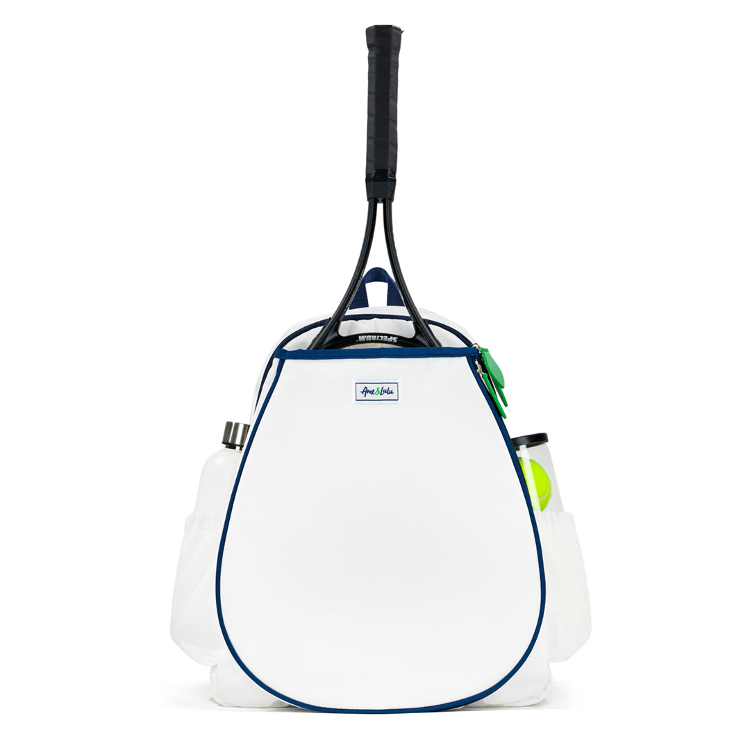 Front view of white tennis backpack with racquet pocket. Bag has navy trim and green zipper pulls.