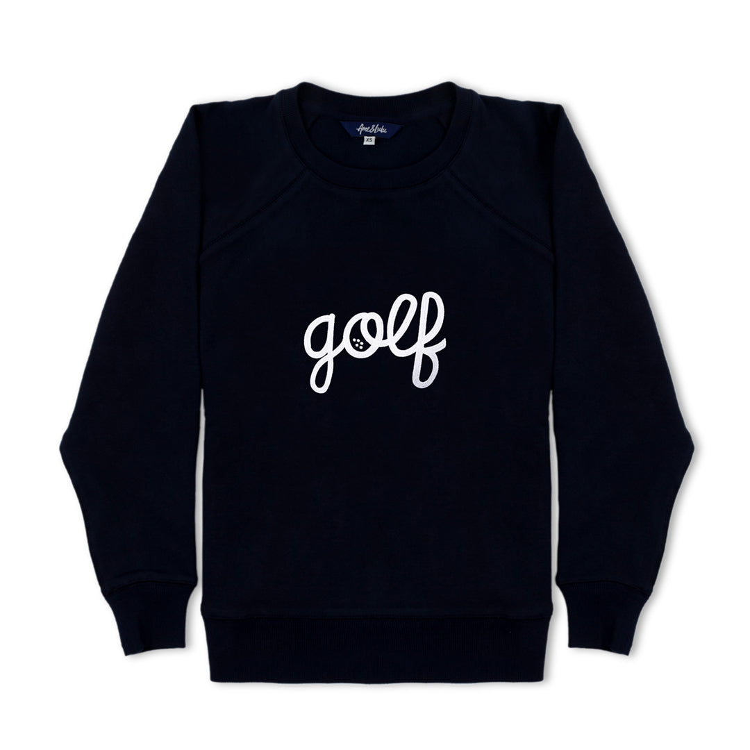 flat laying navy sweatshirt with the word golf embroidered on the front in white cursive text