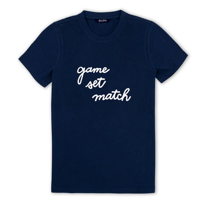 Navy t shirt lays flat on a white background with the words "game set match" embroidered on the front in white