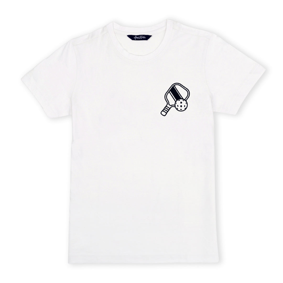 White t-shirt lays flat on a white background with a navy pickleball paddle and pickleball embroidered on the pocket area