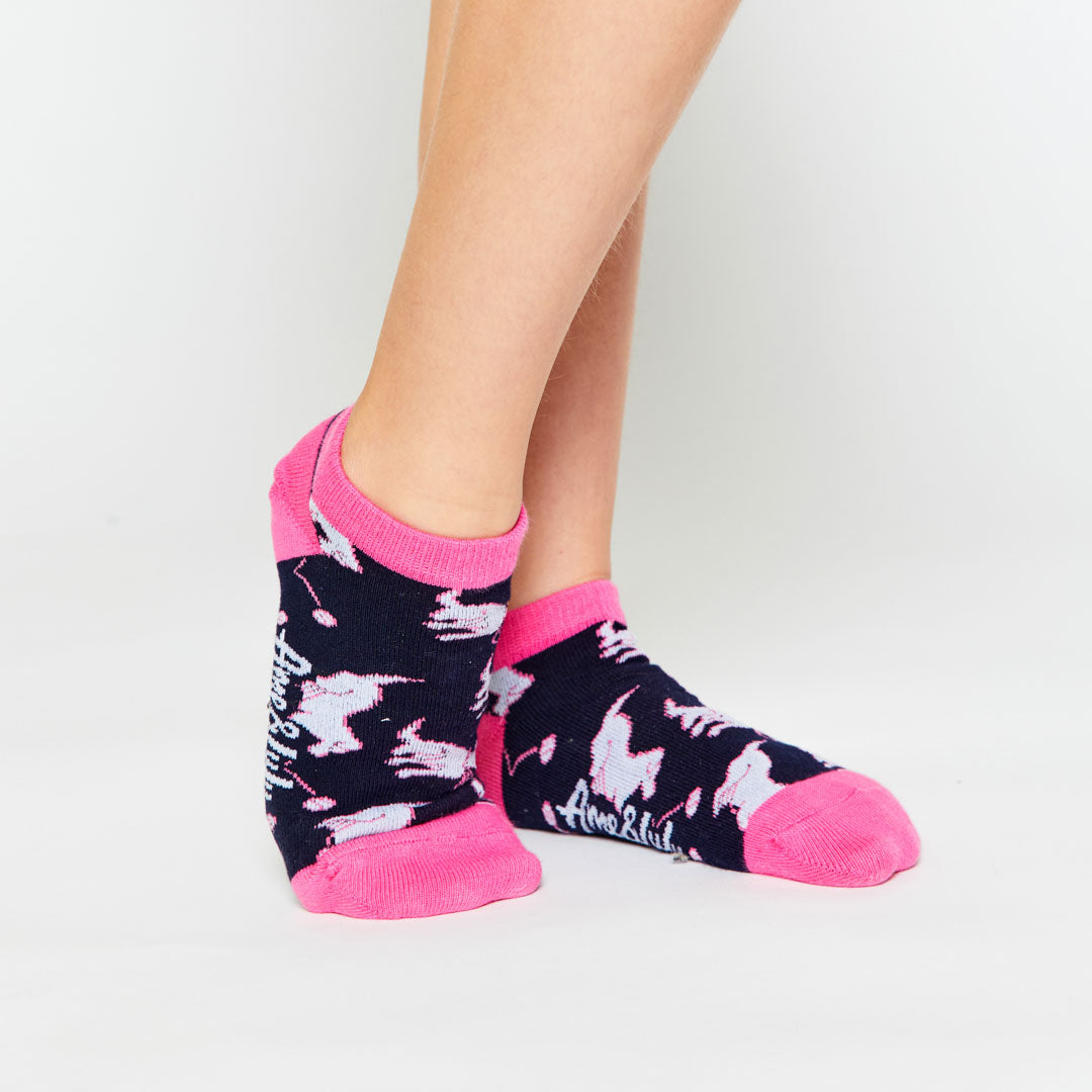 girl wearing pair of navy kids socks with hot pink heel and toes with white puppies stitched on socks