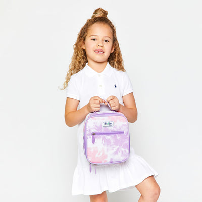 little girl holding pink and purple tie dye kids lunch box