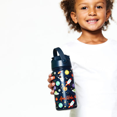 Little girl holding navy kids water bottle with space, planet, spaceship astronaut tennis pattern