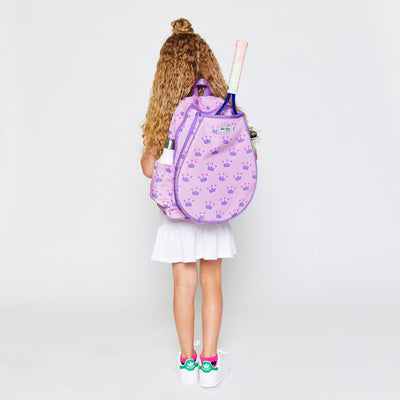 little girl wears a light pink kids tennis backpack with purple trim and purple crown repeating pattern