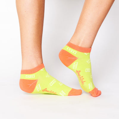 woman wears yellow socks with red trim and white tennis court pattern