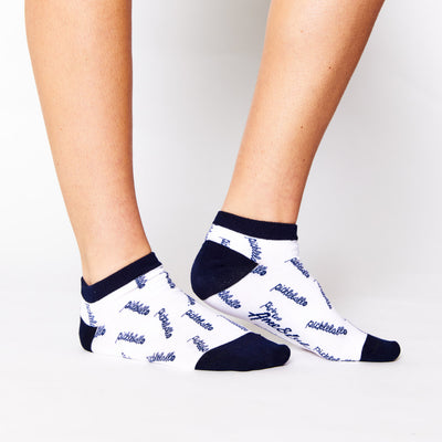 woman wearing white ankle socks with pickleball script text repeated